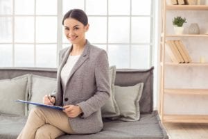 woman sitting on couch excited to explain cbt vs dbt