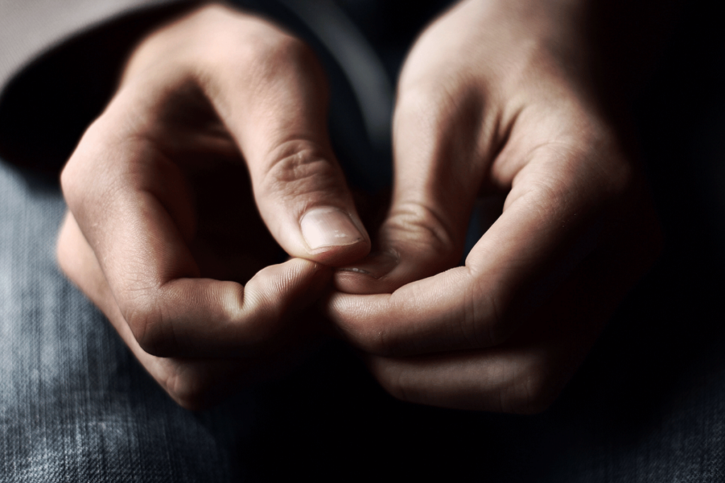 a photo of person hands touching together as the person thinks about meth withdrawal symptoms